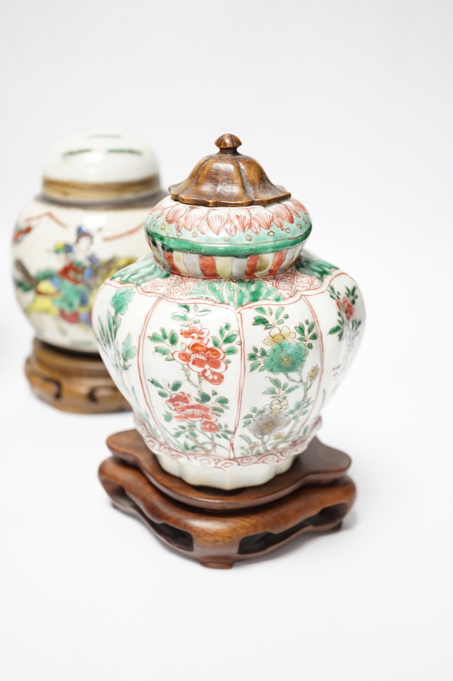 A Chinese famille verte vase, Kangxi period (cut down) and three Chinese polychrome jars with hardwood stands, tallest 19cm